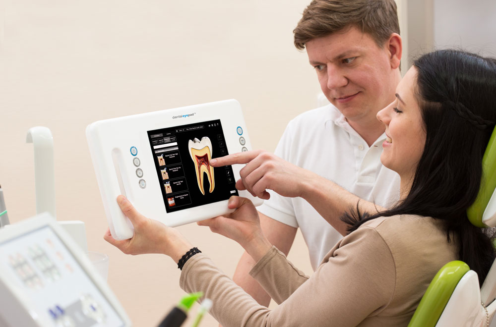 The patient is shown something on the Dentaleyepad.